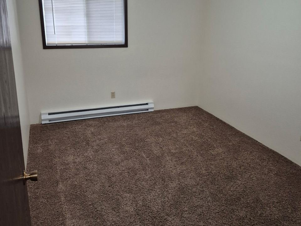 Carpeted bedroom with a window