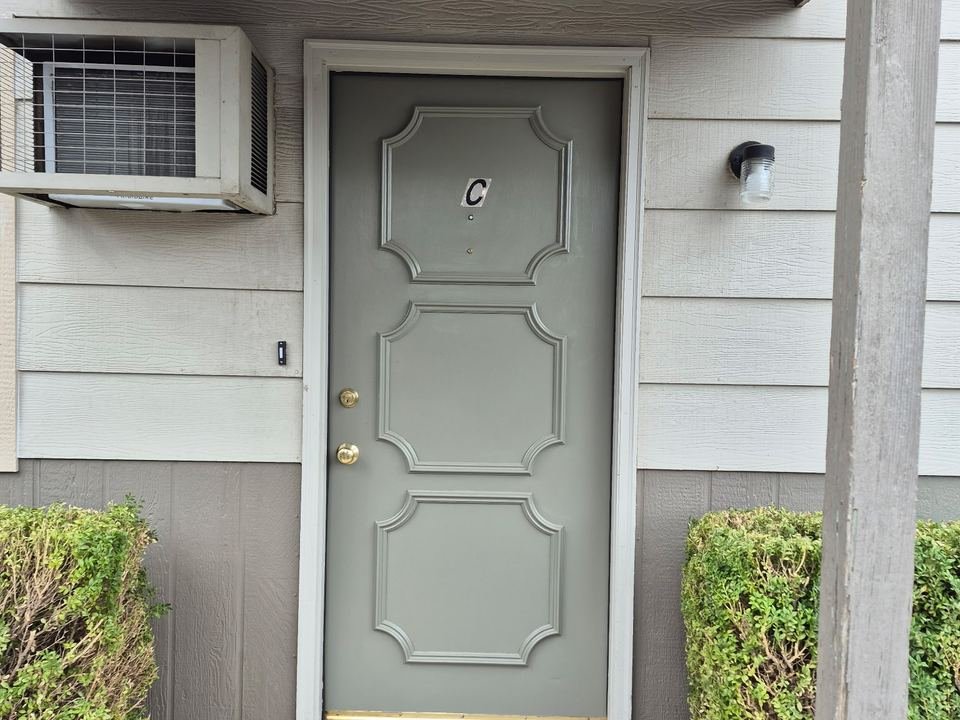 Front door of unit C under a covered porch
