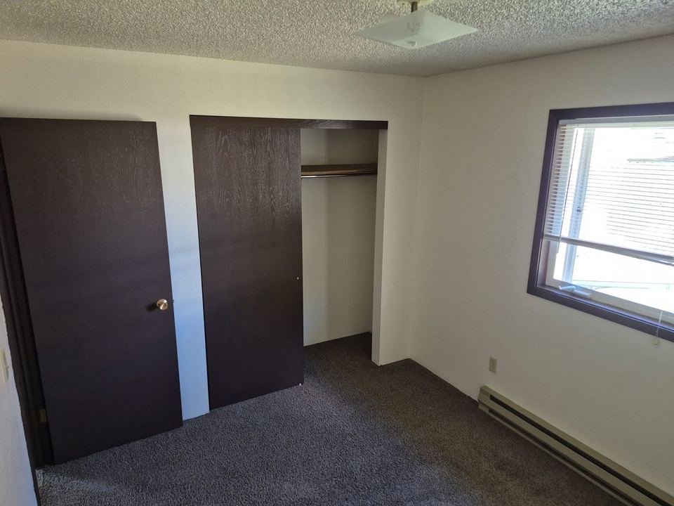 Bedroom with a closet and window