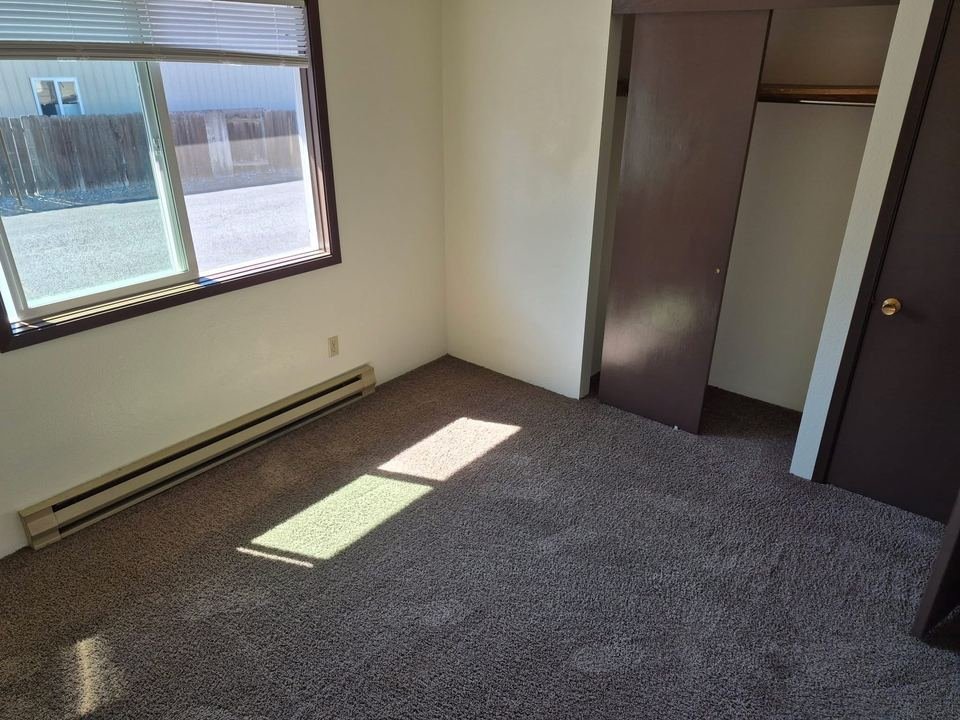 Bedroom with a large window and closet