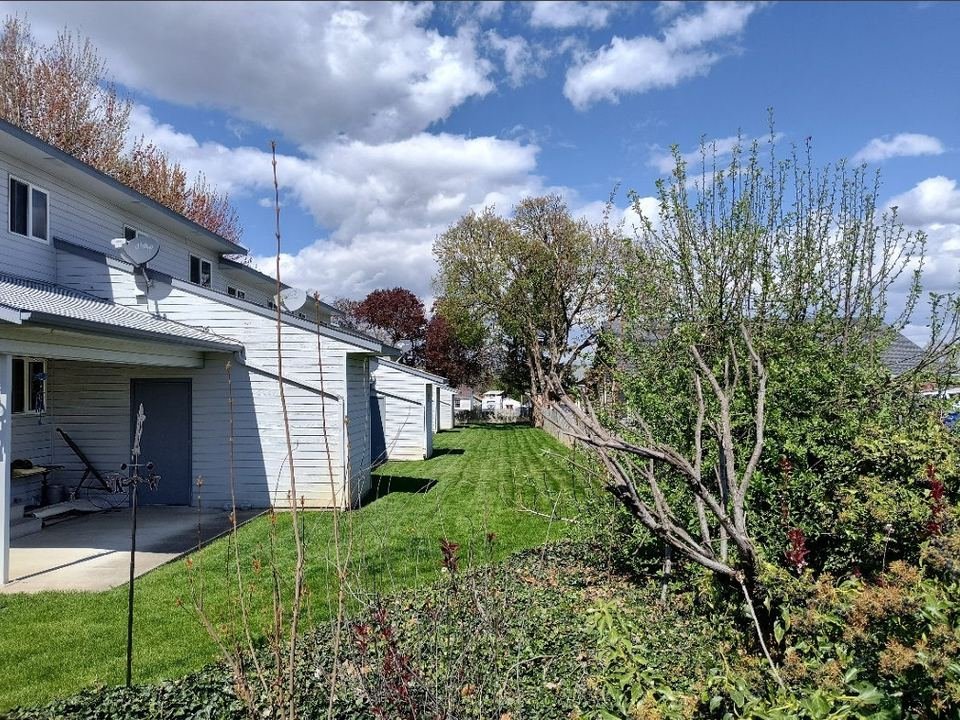 Back of the townhouses with covered patios and lawn